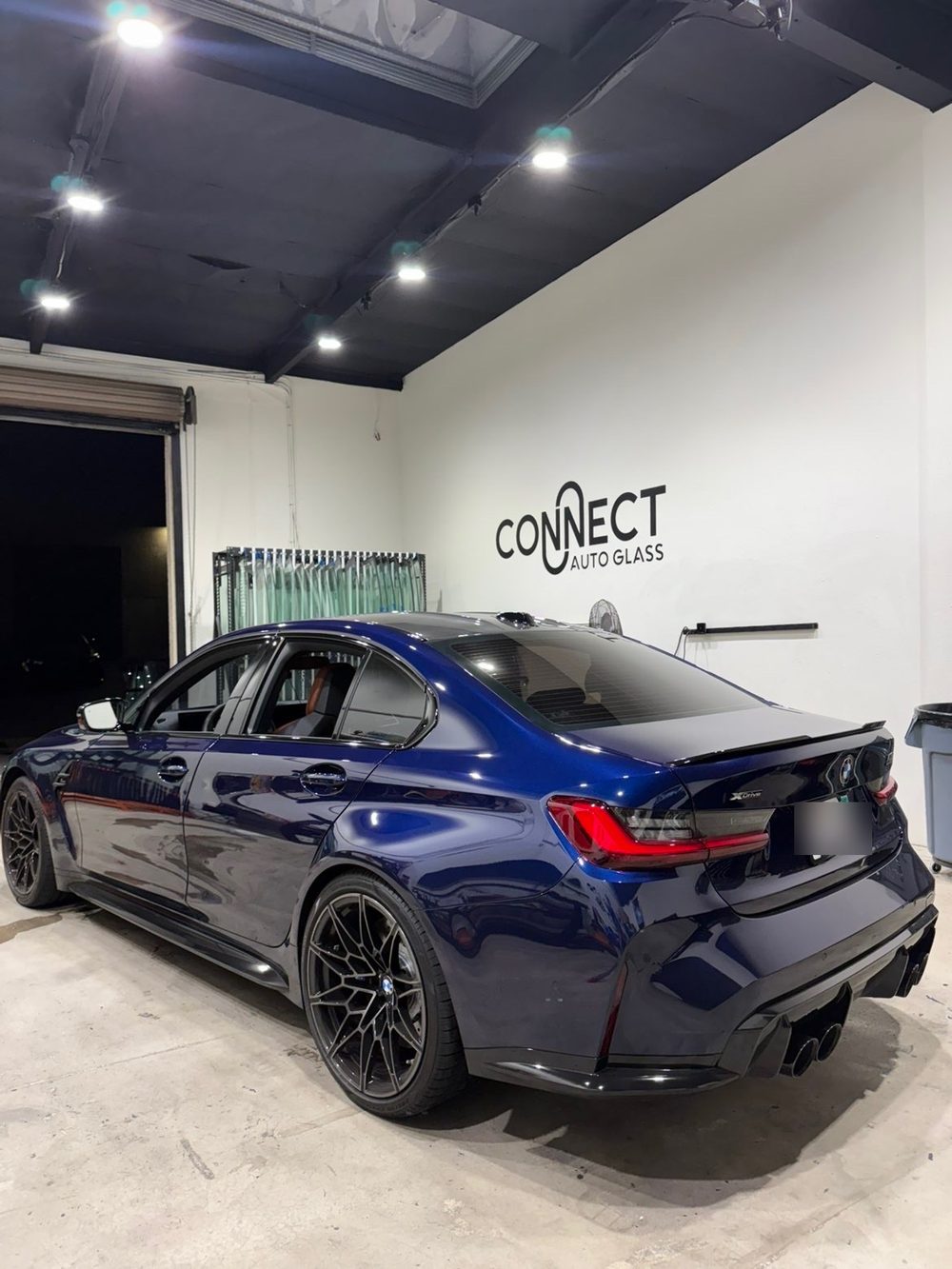 A BMW M3 in the Connect Auto Glass shop in Miramar